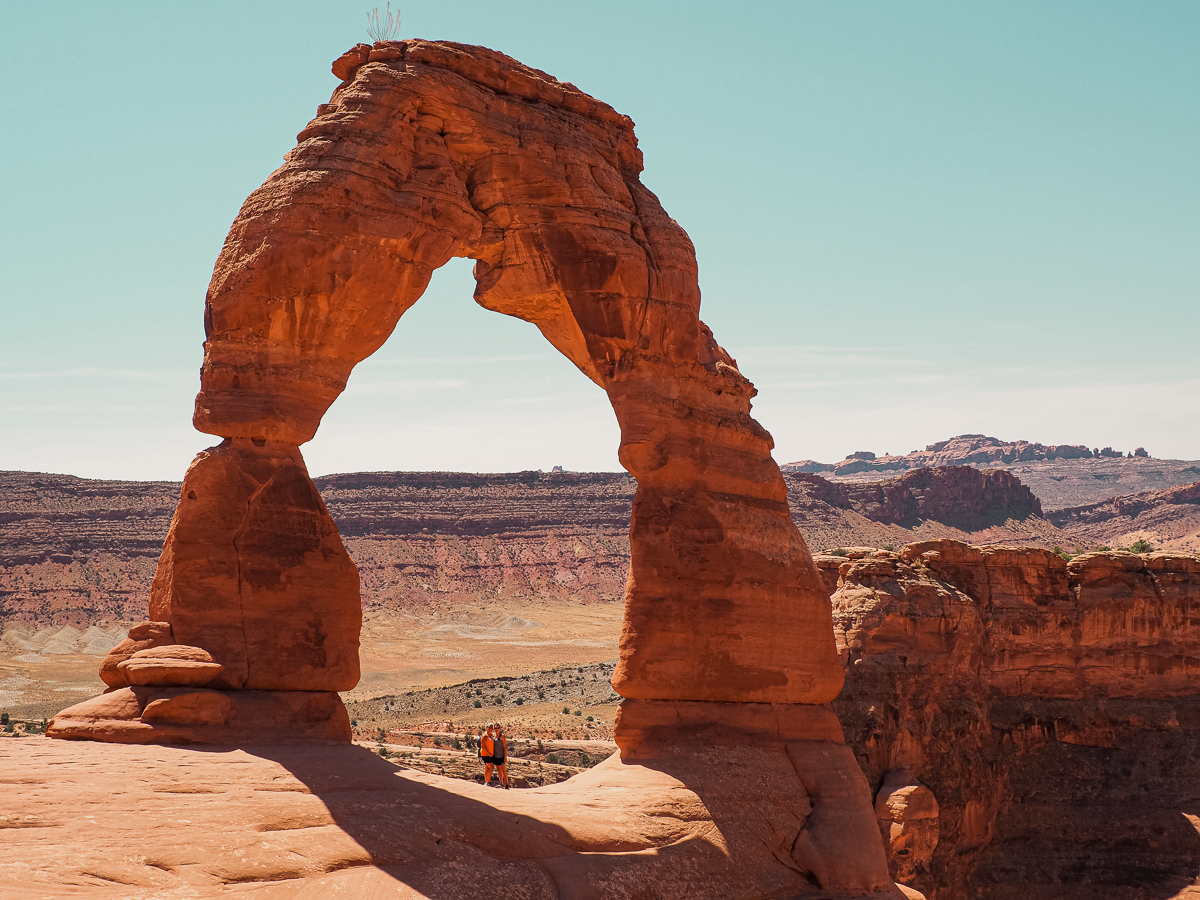 Delicate Arch with us standing underneath in Arches National Park