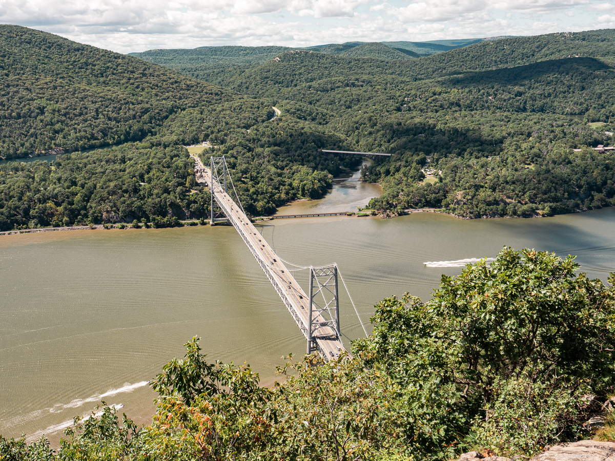 Stunning view of Bear Mountain Bridge, the green lush forests and the Hudson River from Anthony's Nose