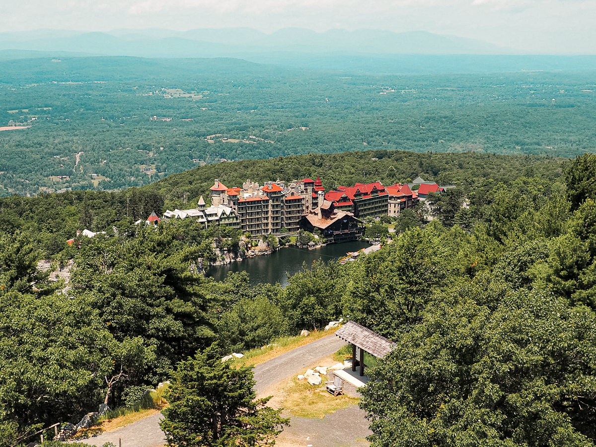 Bird's Eye View of the victorian Mohonk Mountain Resort surrounded by lush forests and the lake