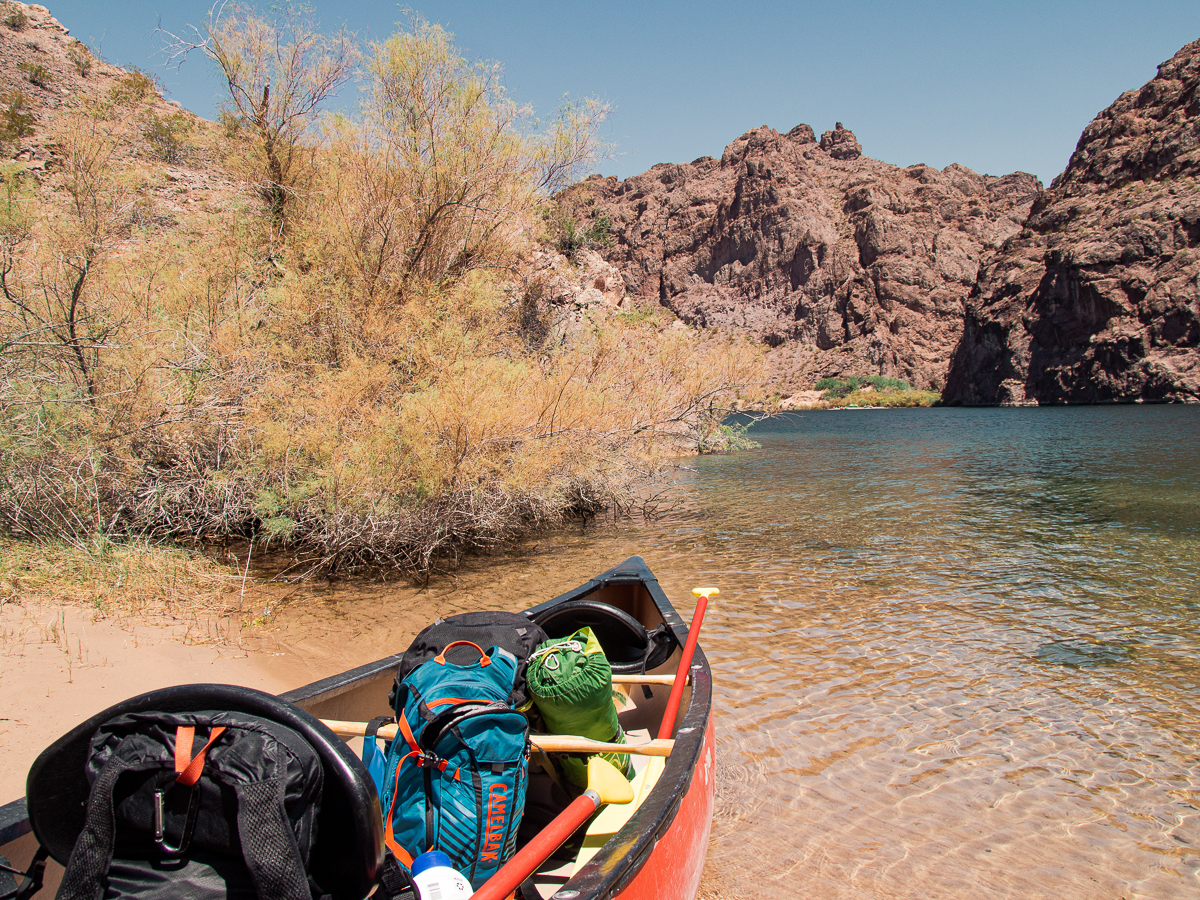 Kayak packing with tent and book bags in the Colorado River