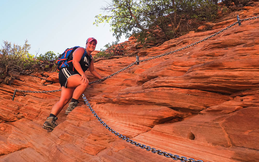 Rachel hanging in the bolted chains to hike Angels Landing