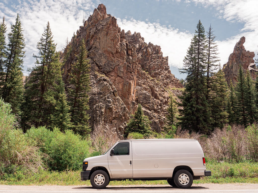 Our van in front of scenic forest with rock formations in Colorado