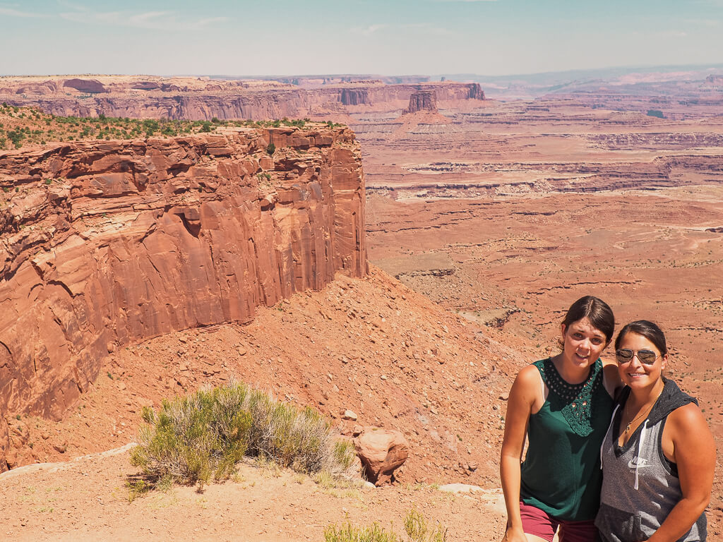 Us standing at the Buck Canyon Overlook with vast landscape in the background