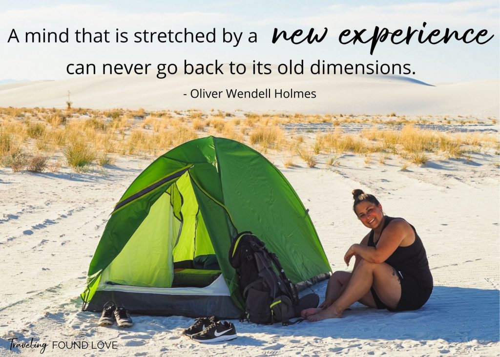 Short travel quote with Rachel sitting next to her tent in the sand